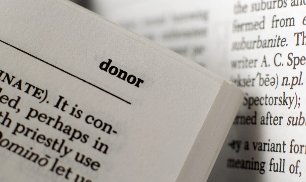 Donor Advised Funds to Make the Most of Your Charitable Giving | Picture of dictionary opened to the word donor