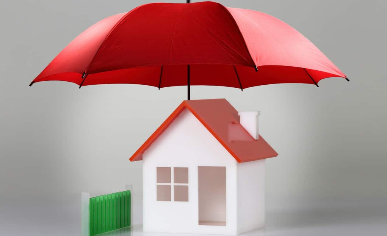How Insurance reinforces your financial legacy | Red umbrella covering a house