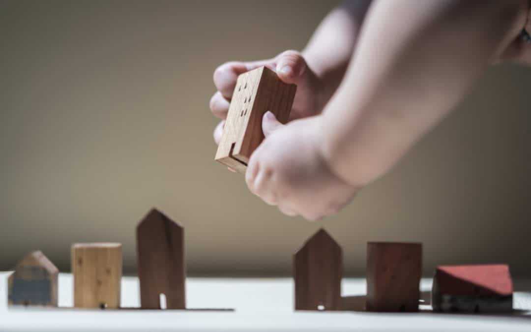 The Charitable Legacy Planning Mindset | A baby building a city with blocks